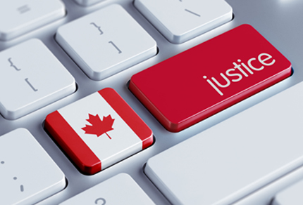 Close up of two keyboard keys, one with the Canadian flag and another red key with "Justice" in white lettering.